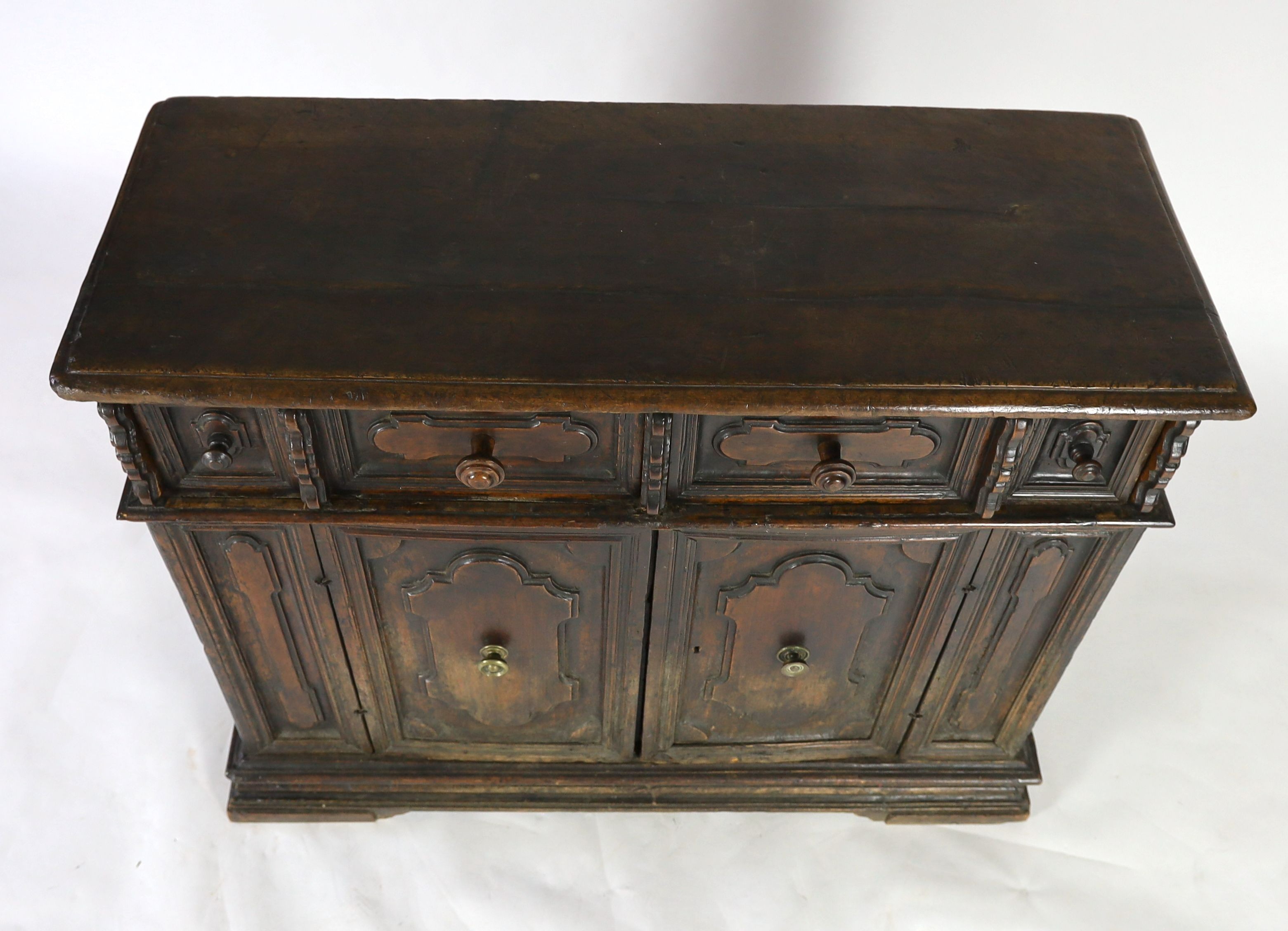 A 17th century Tuscan walnut credenza, W.131cm D.52cm H.105cm